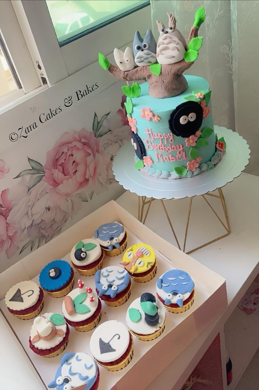 Mint green Totoro themed birthday cake with fondant characters and matching Ghibli cupcakes