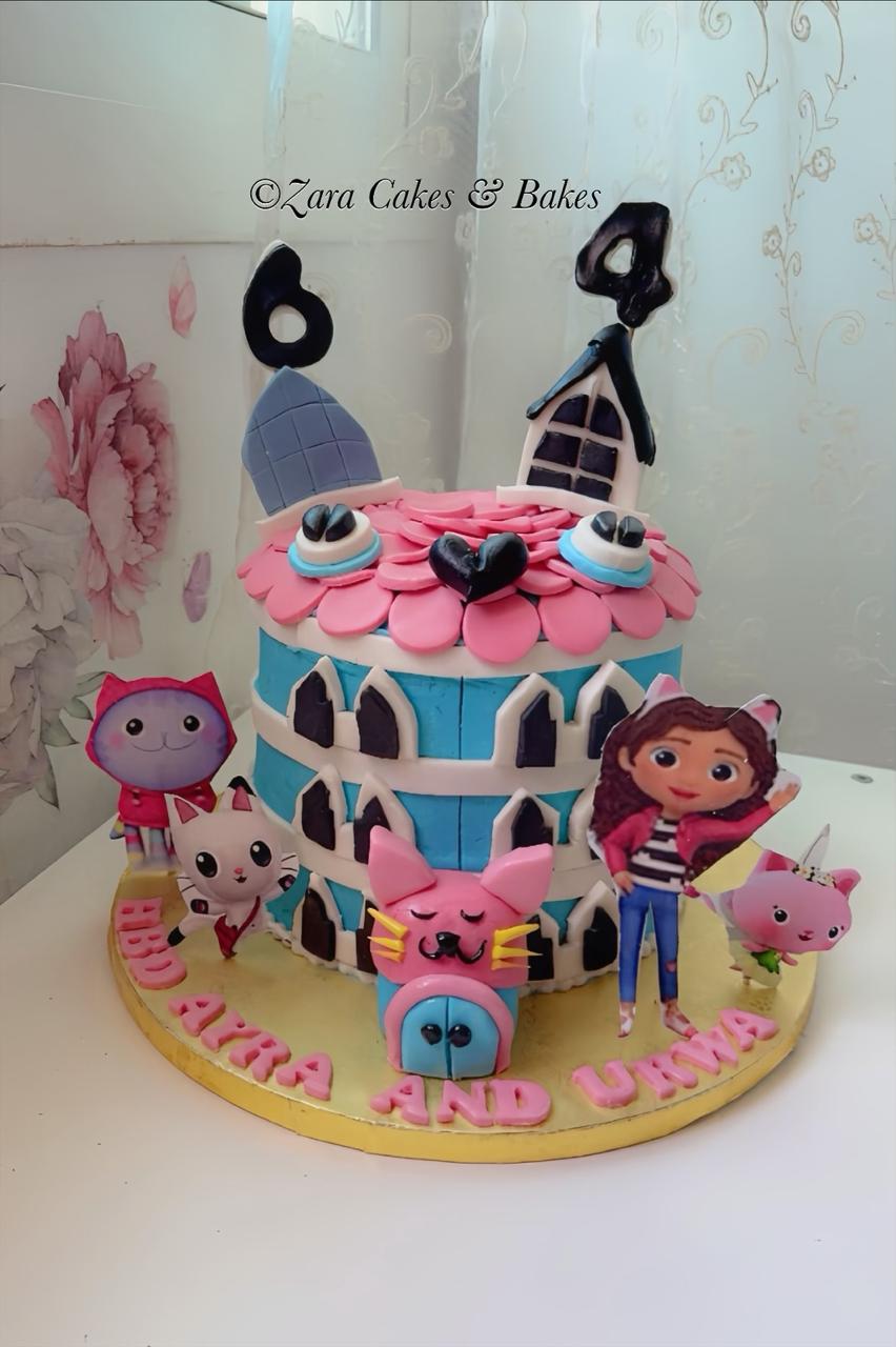 Colorful Gabby's Dollhouse birthday cake with blue fondant walls, pink roof, and character figurines