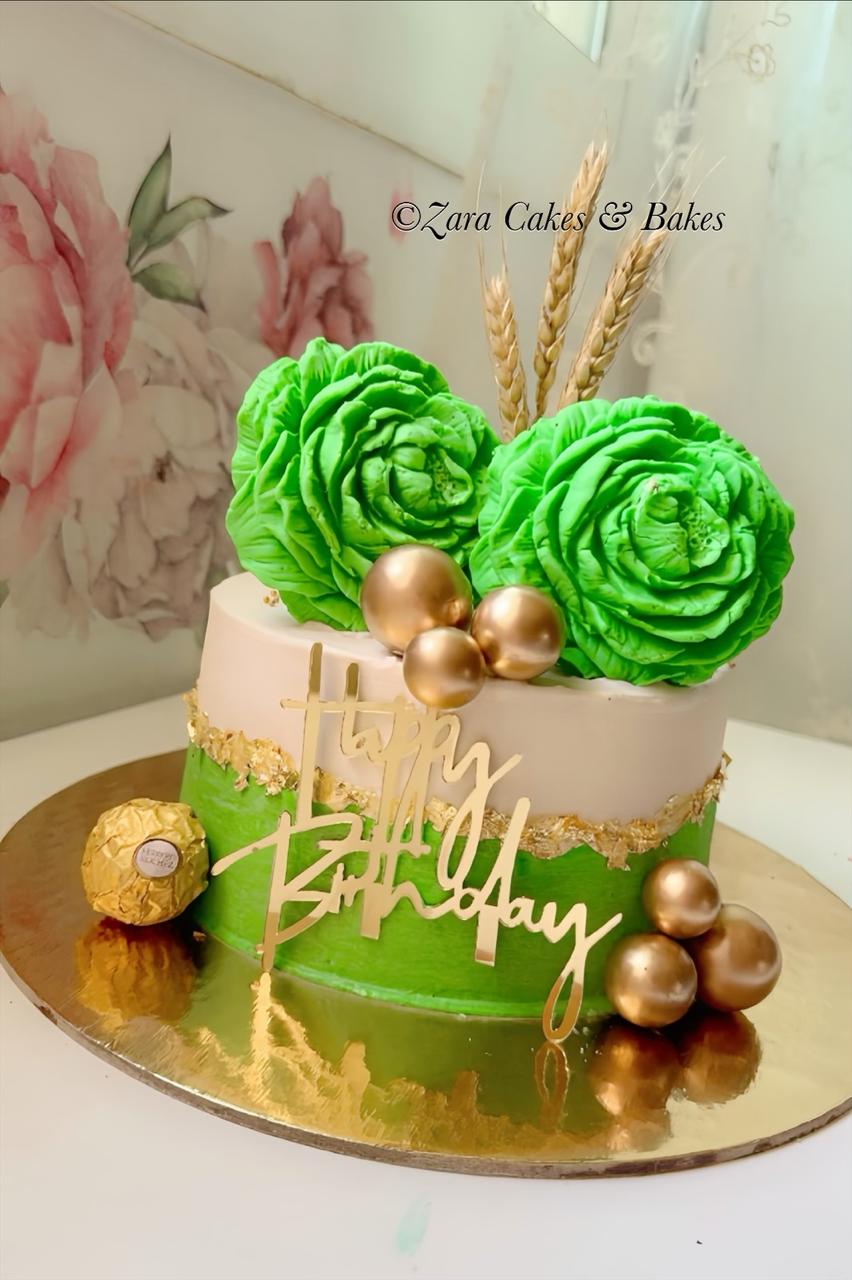 Emerald green and white birthday cake with gold leaf, buttercream roses and golden spheres