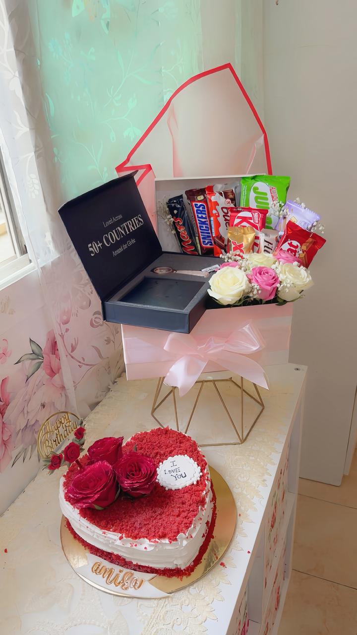 Heart shaped red velvet cake with fresh roses and chocolate bouquet gift box from Zara Cakes Riyadh