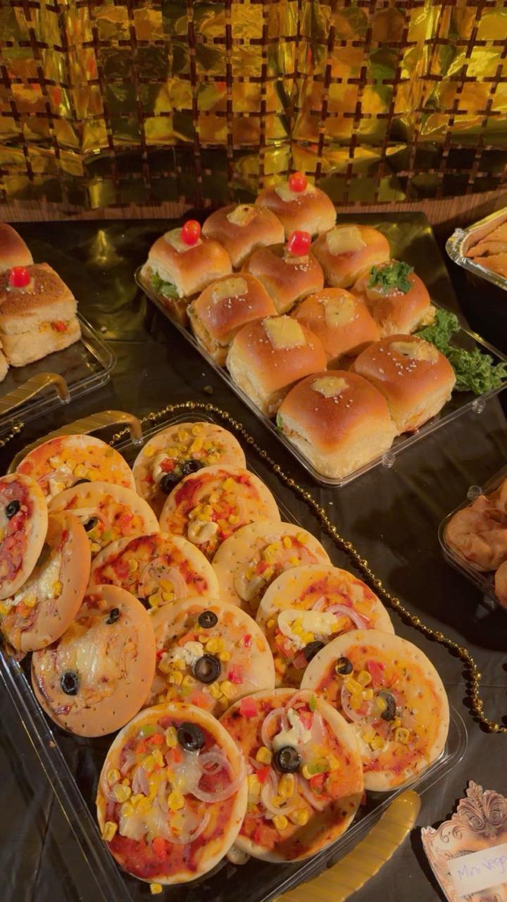 Savory mini pizzas and cheese sliders party platter from Zara Cakes Riyadh
