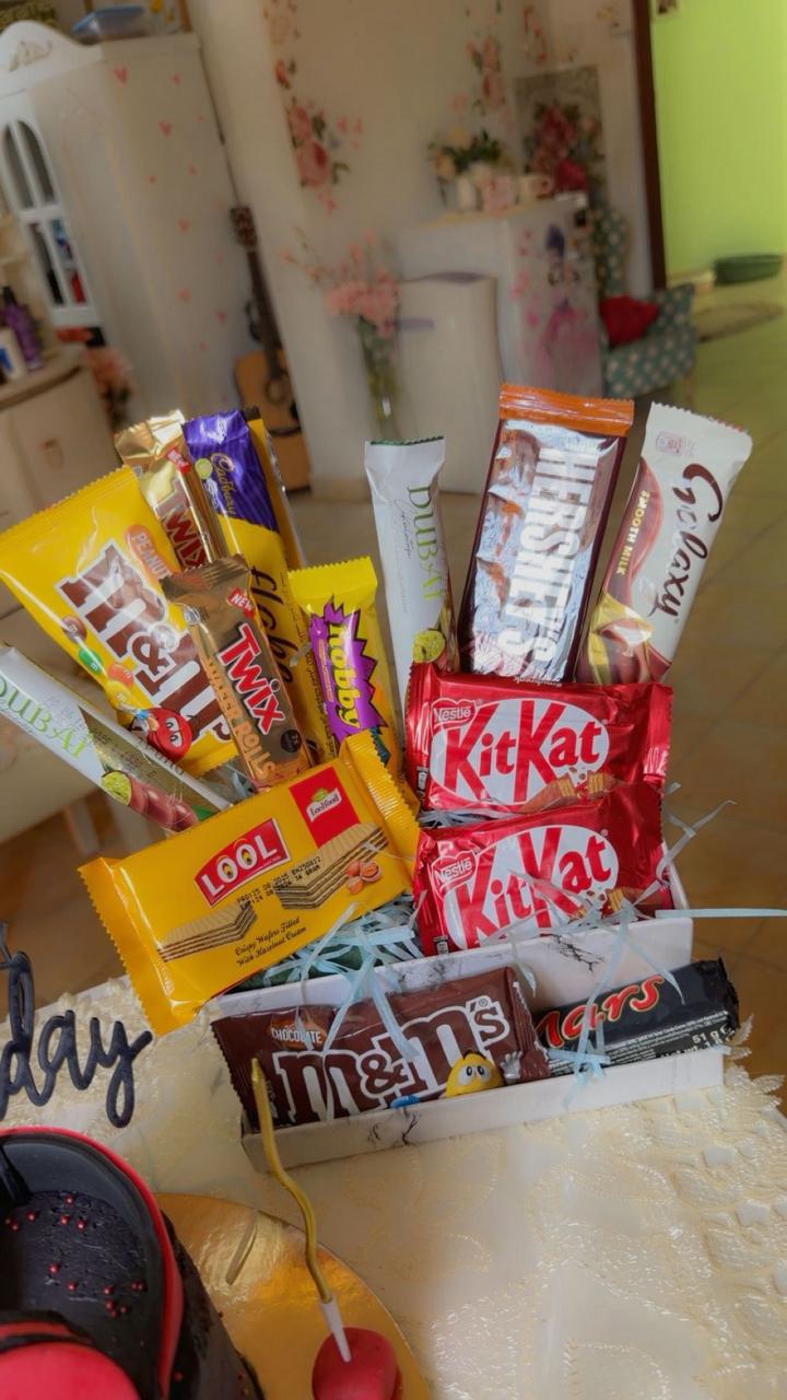 Luxury chocolate candy bouquet with KitKat, M&M's, and Twix in a white gift box from Zara Cakes Riyadh