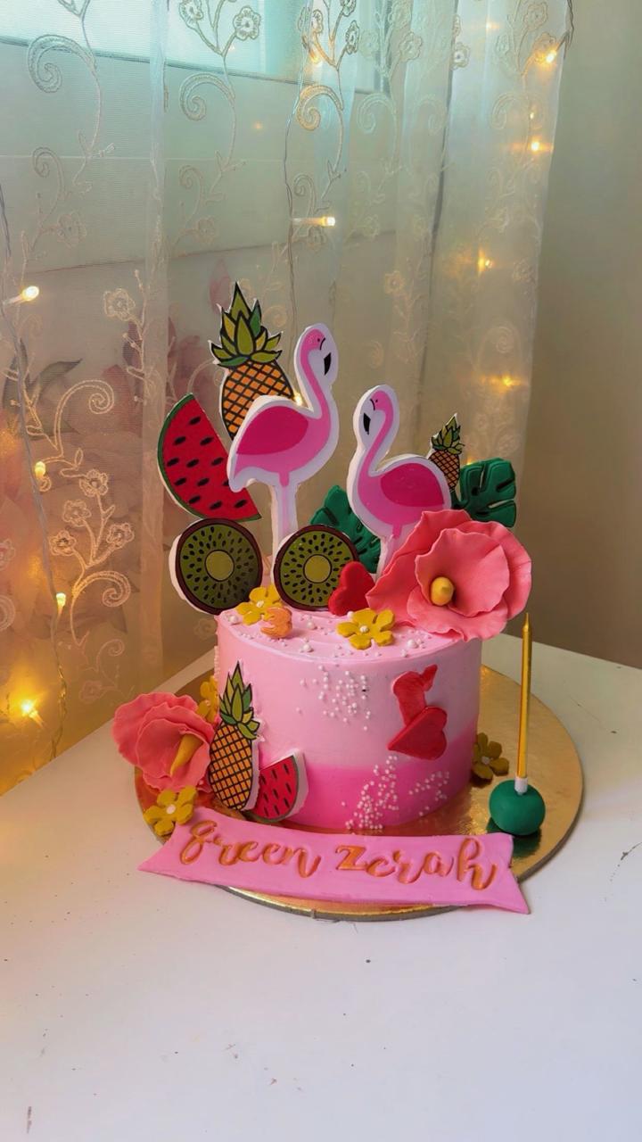 Tropical flamingo themed pink ombre birthday cake with fruit and flowers from Zara Cakes Riyadh.