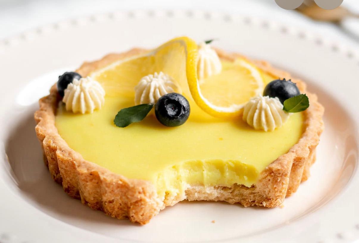 Delicious lemon custard tart with fresh blueberries and whipped cream from Zara Cakes Riyadh